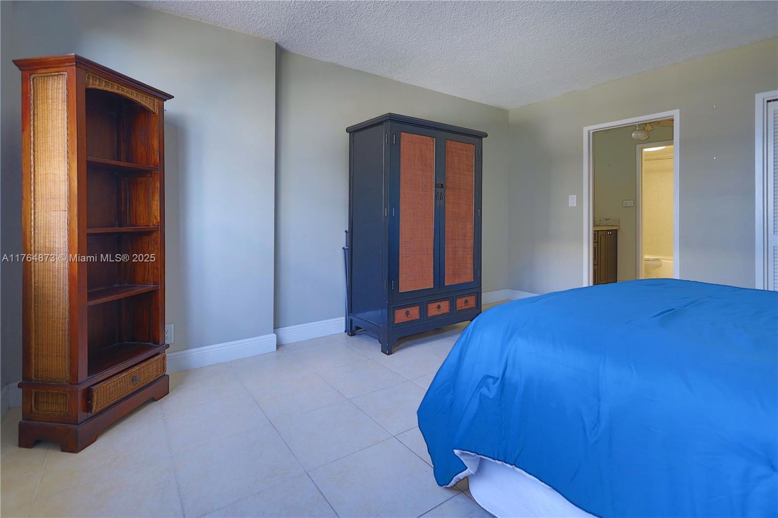 9225 Collins Avenue, Unit 503 Surfside, FL 33154 - Photo 6 of 37 a bedroom with a bed and dresser