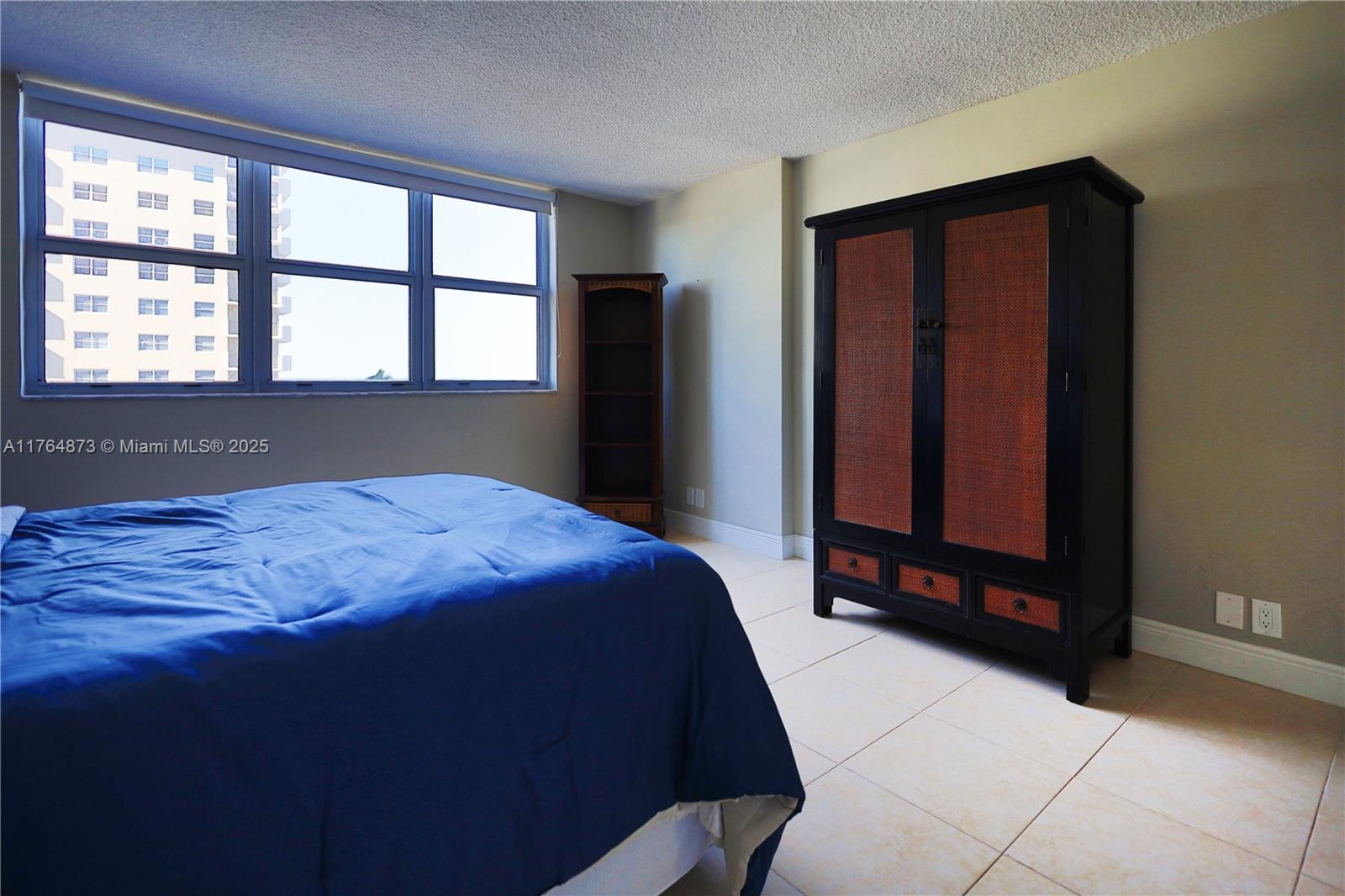 9225 Collins Avenue, Unit 503 Surfside, FL 33154 - Photo 7 of 37 a bedroom with a bed and window