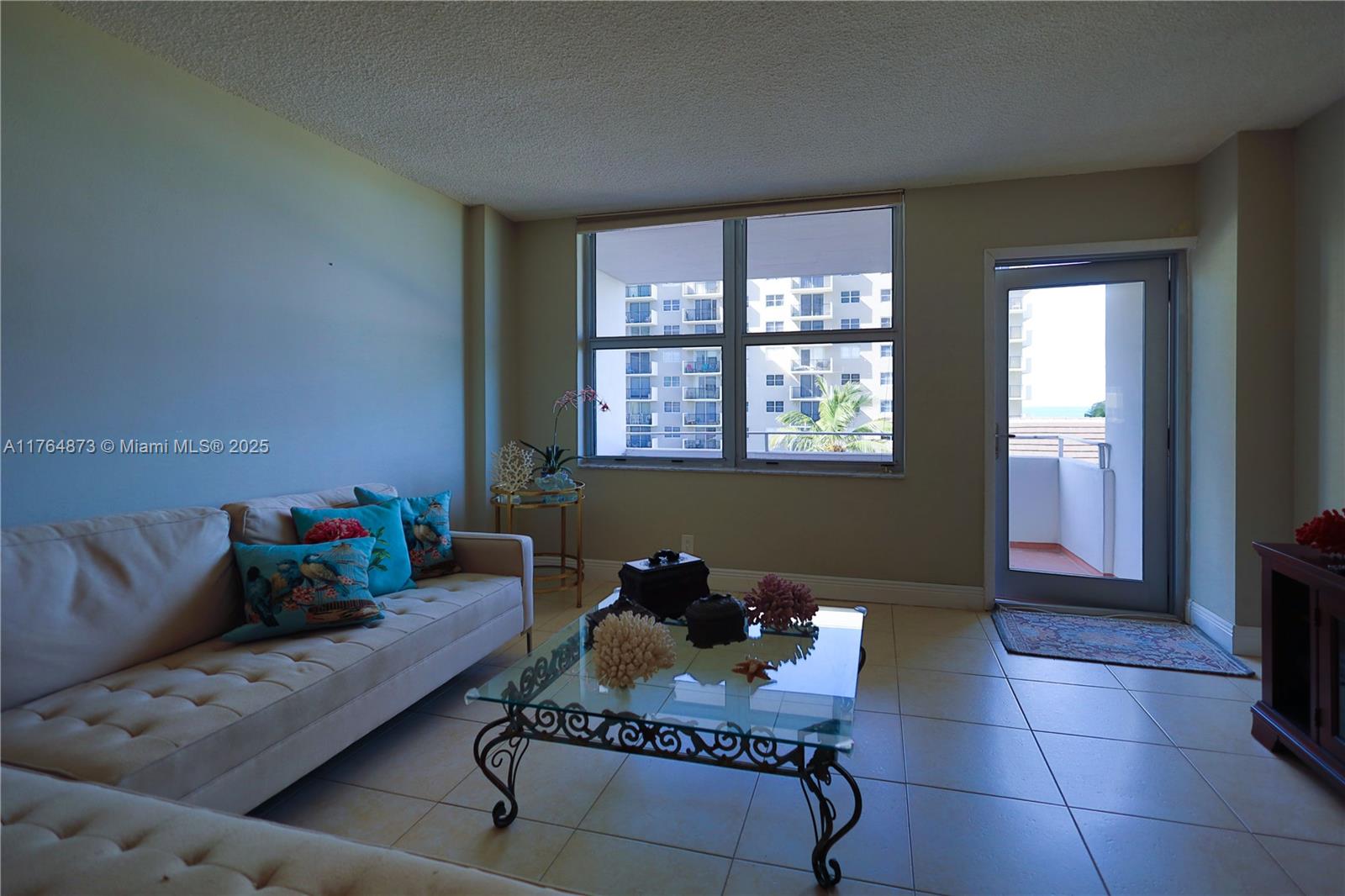 9225 Collins Avenue, Unit 503 Surfside, FL 33154 - Photo 9 of 37 a living room with furniture and a potted plant