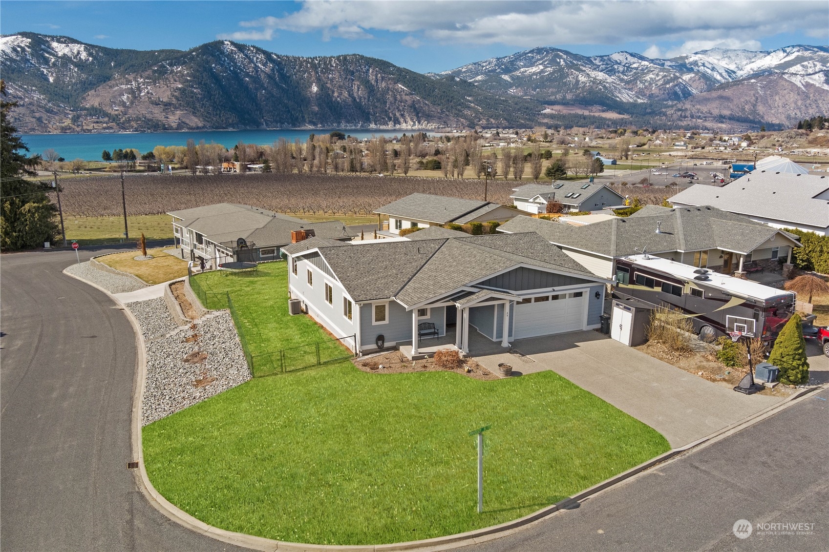 an aerial view of a house with a garden and lake view