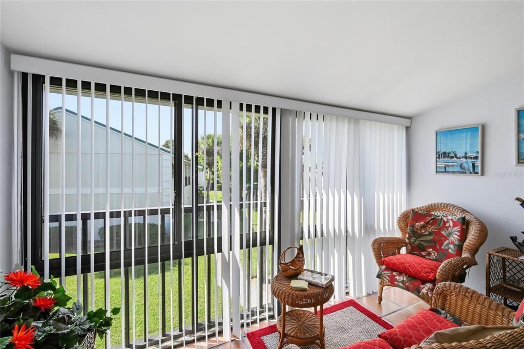 5683 Midnight Pass Road, Unit 110 Sarasota, FL 34242 - Photo 15 of 19 a living room with furniture and a potted plant