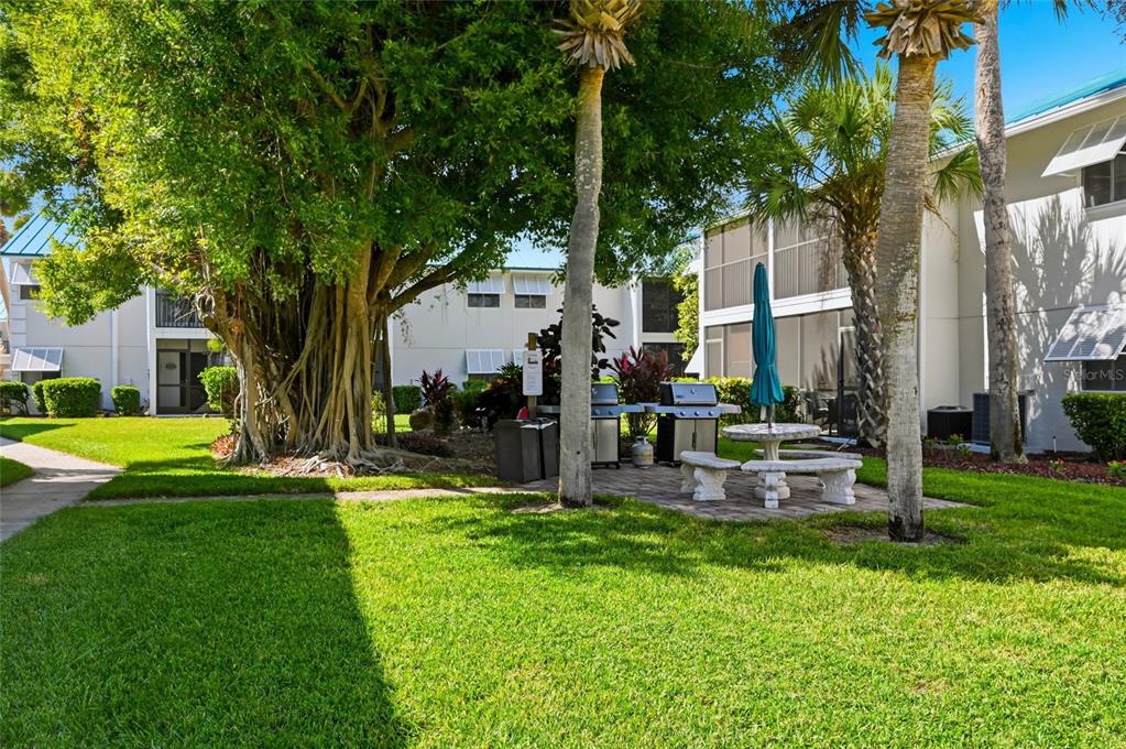 5683 Midnight Pass Road, Unit 110 Sarasota, FL 34242 - Photo 17 of 19 a view of a house with a backyard