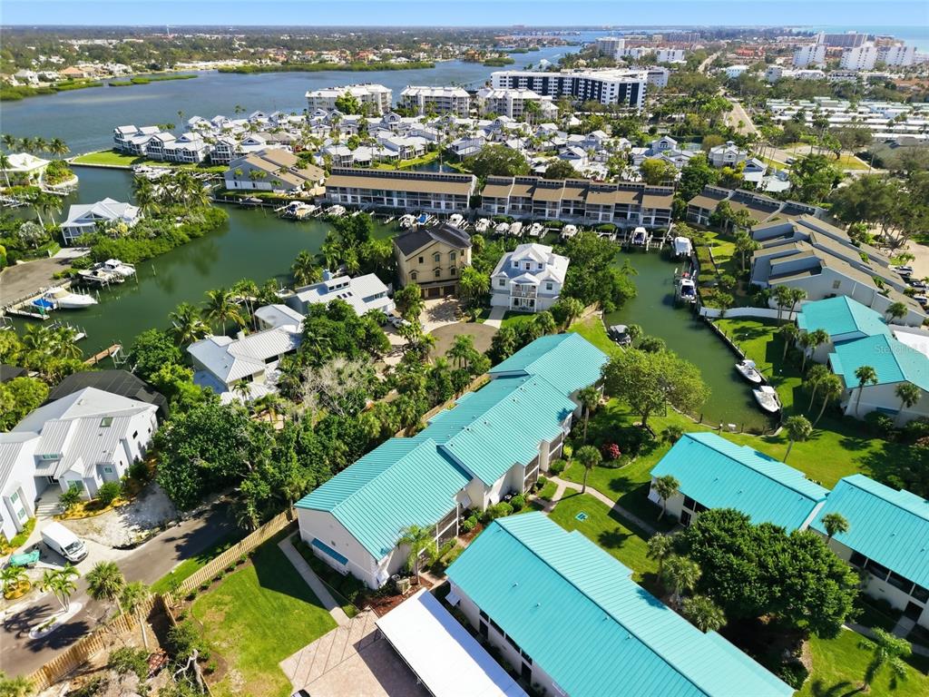 5683 Midnight Pass Road, Unit 110 Sarasota, FL 34242 - Photo 2 of 19 an aerial view of residential houses with outdoor space
