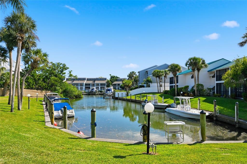 5683 Midnight Pass Road, Unit 110 Sarasota, FL 34242 - Photo 3 of 19 a view of a lake with a house in the background