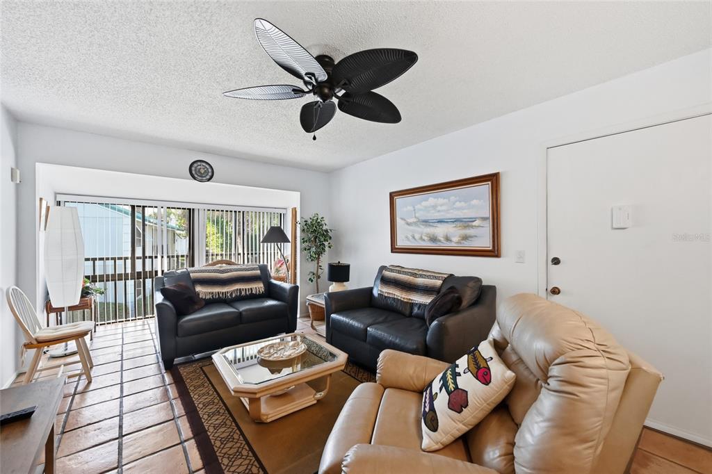 5683 Midnight Pass Road, Unit 110 Sarasota, FL 34242 - Photo 8 of 19 a living room with furniture and a large window