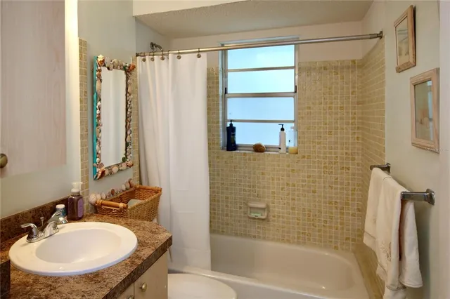 a bathroom with a sink a bathtub and a shower