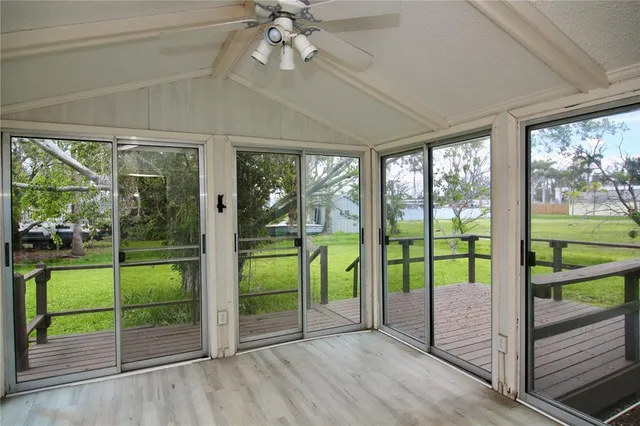 a view of a room with window ceiling fan