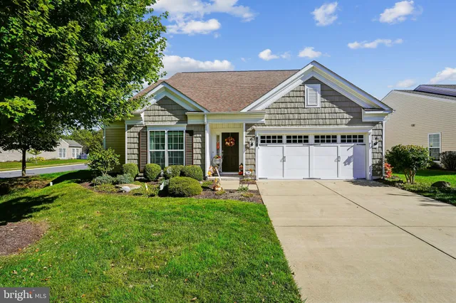 a front view of a house with a yard table and chairs