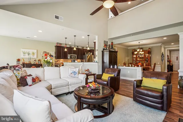 a living room with furniture and a view of kitchen