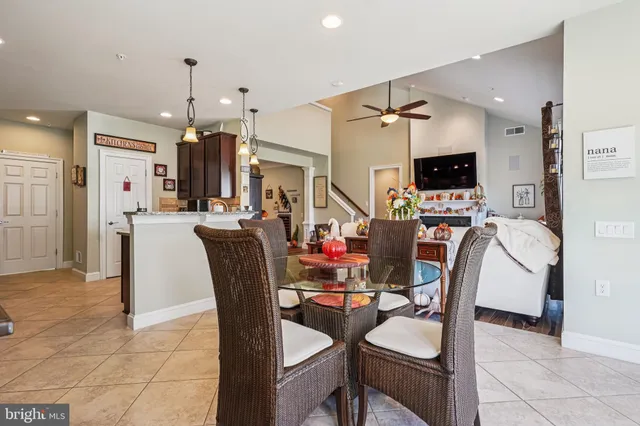 a view of a dining room with furniture and a chandelier