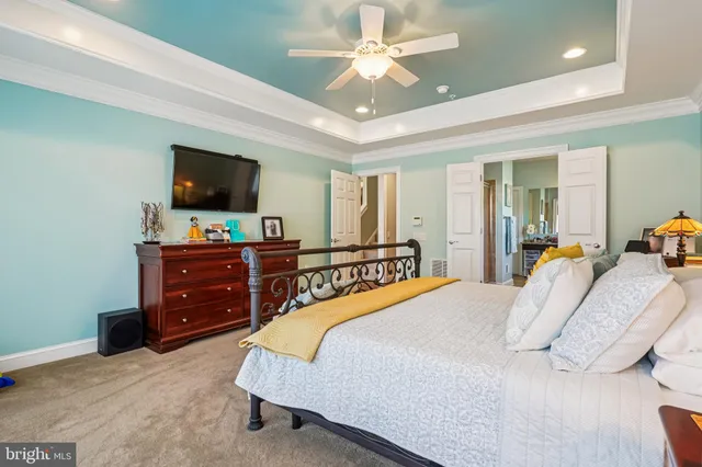 a bedroom with a bed window and a flat screen tv