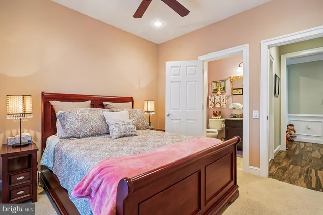 a bedroom with a large bed and a chandelier