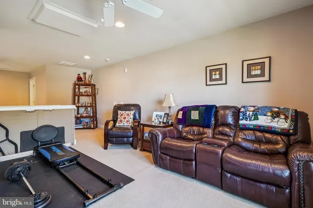 a room with furniture gym equipment and a large window