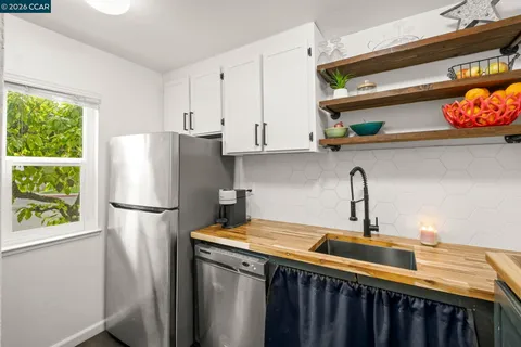 a white refrigerator freezer sitting inside of a kitchen