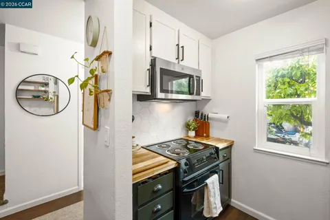 a kitchen with a stove and a window