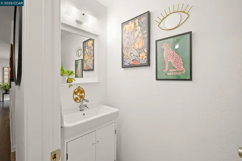 a bathroom with a sink mirror and vanity