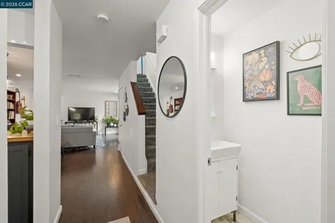 a view of a hallway to a livingroom and a kitchen