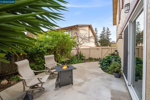 a view of a patio with table and chairs and potted plants