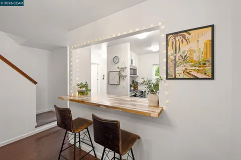 a view of a dining room with furniture and a potted plant