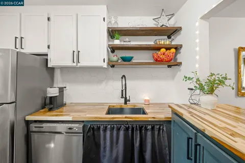 a kitchen with stainless steel appliances a sink and cabinets