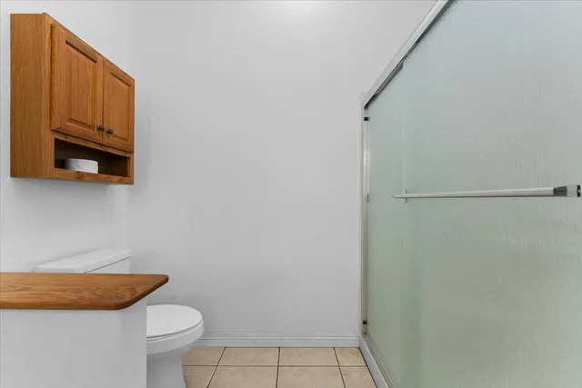 a view of a small yard in front of a house with a large tree