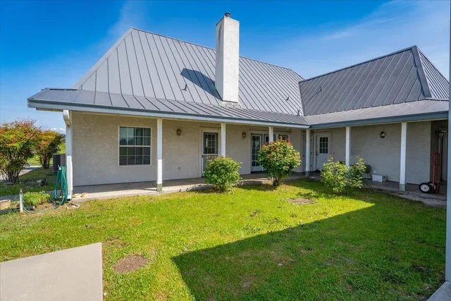 a aerial view of a house with a garden and lake view