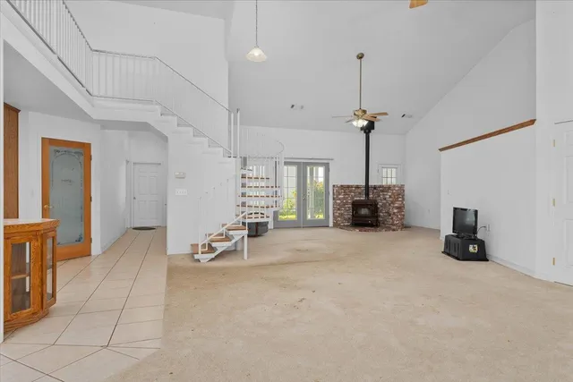 a view of an empty room and a kitchen