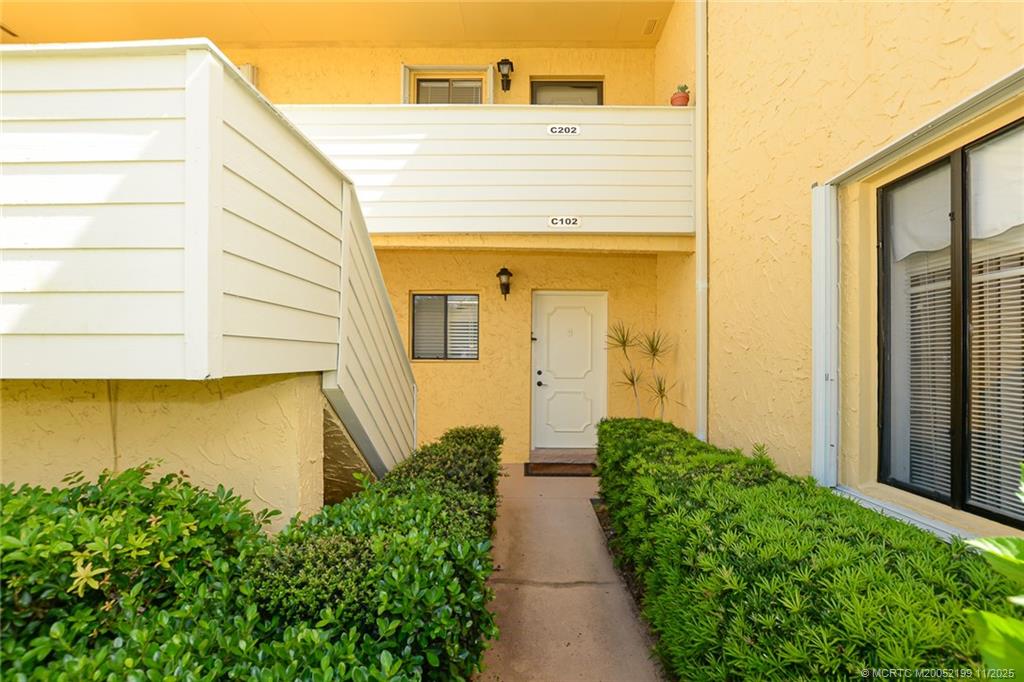 5373 Southeast Miles Grant Road, Unit C102 Stuart, FL 34997 - Photo 2 of 21 First floor with golf view! Accordian hurricane shutters