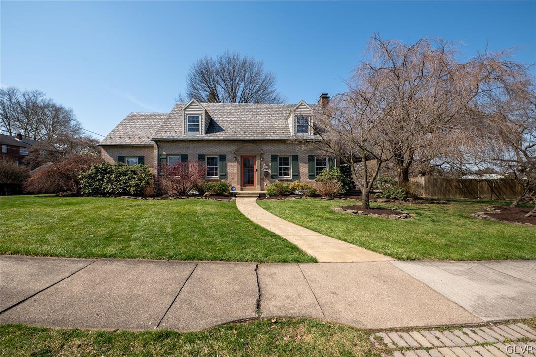 a front view of a house with a garden