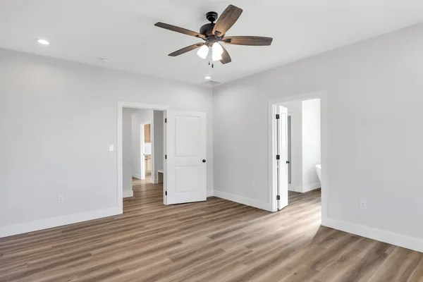a view of an empty room with wooden floor