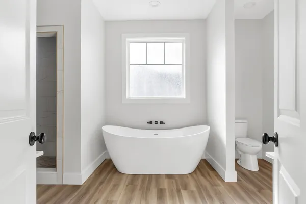 a white bath tub sitting next to a white toilet