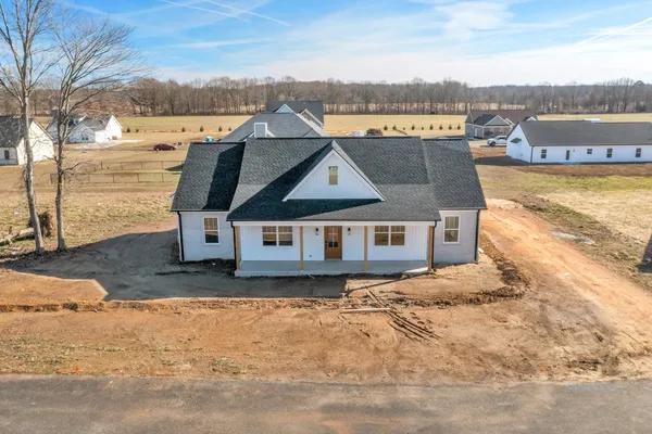 an aerial view of a house with a yard