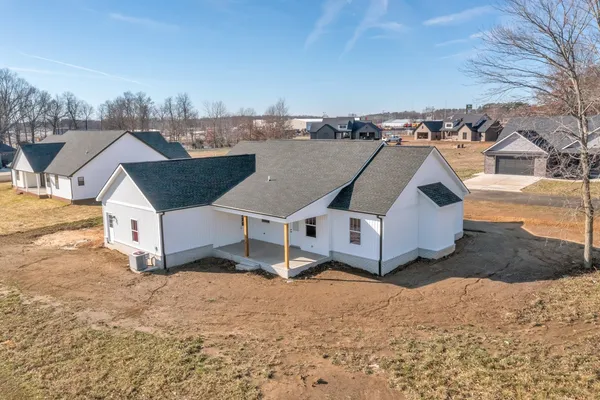an aerial view of a house with a yard