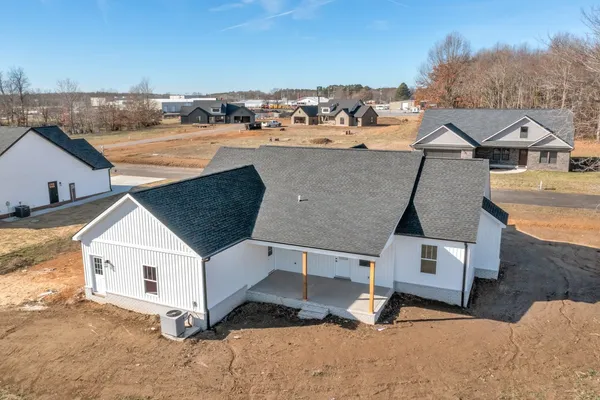 an aerial view of a house with a yard and garage