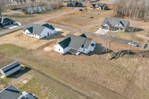 an aerial view of residential houses with outdoor space