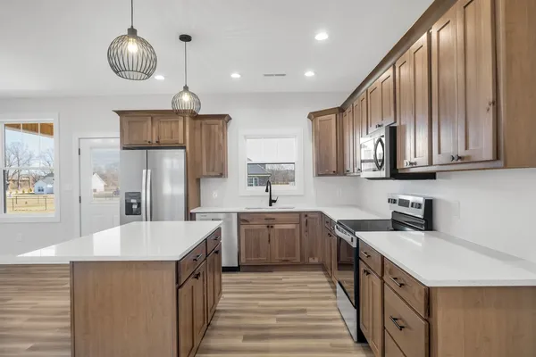 a kitchen with stainless steel appliances a sink stove and refrigerator