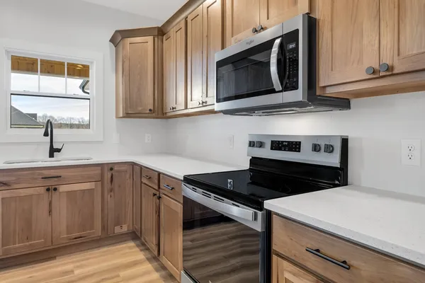 a kitchen with stainless steel appliances granite countertop a sink and cabinets
