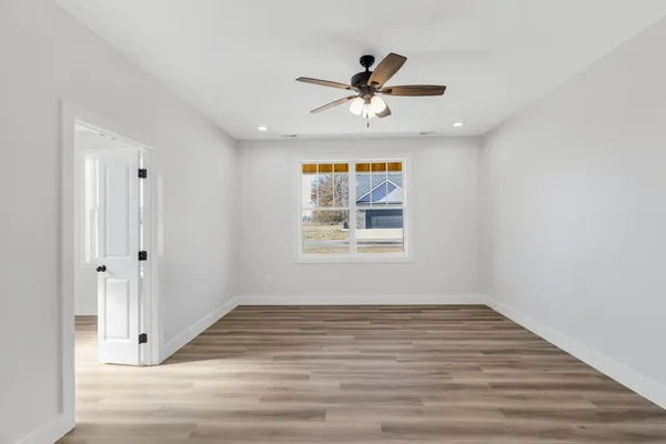 a view of a big room with wooden floor closet and windows