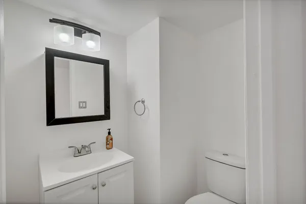 a bathroom with a toilet sink and mirror