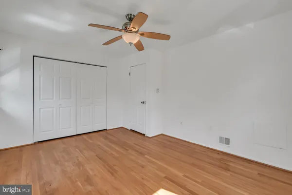a view of a room with wooden floor