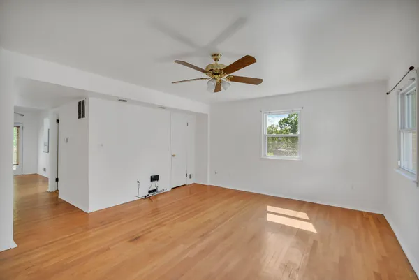 wooden floor in an empty room with a window