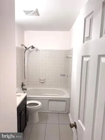 a bathroom with a toilet a sink and bathtub