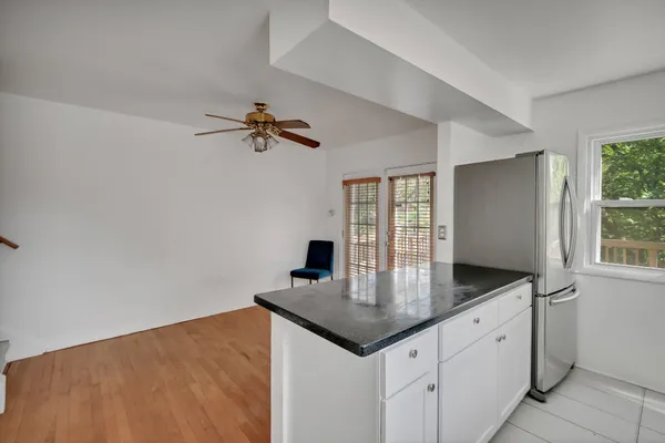 a kitchen with stainless steel appliances granite countertop a sink window and cabinets
