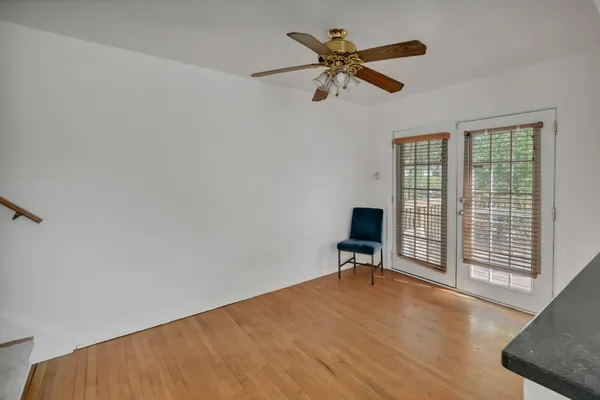 a view of a livingroom with a ceiling fan and a window