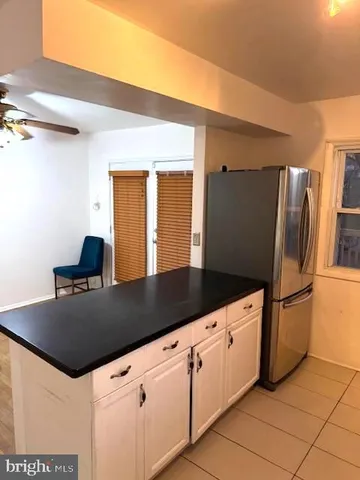 a view of a room with wooden floor and a ceiling fan
