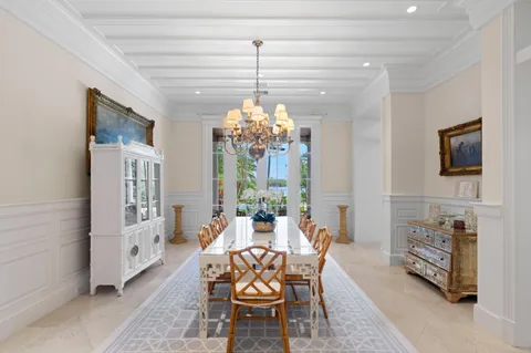 a dining room with furniture a chandelier and window