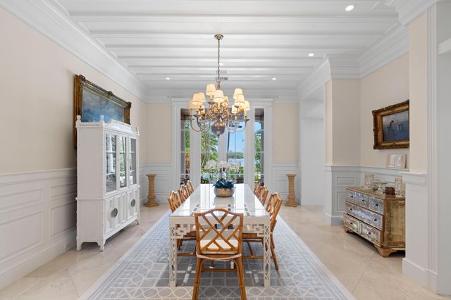 a dining room with furniture a chandelier and window