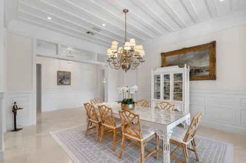 a dining room with furniture and chandelier