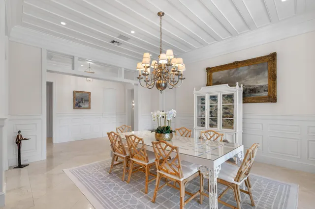a dining room with furniture and chandelier