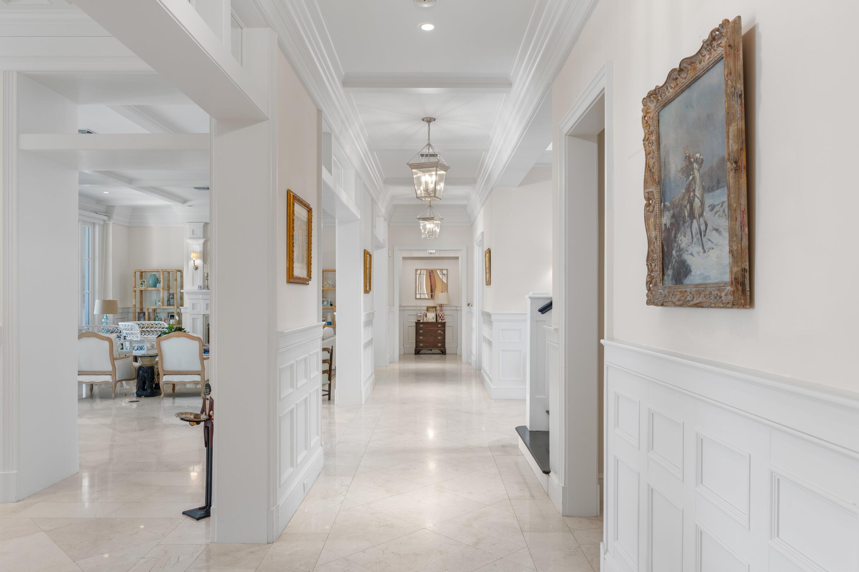 202 Gomez Road Hobe Sound, FL 33455 - Photo 13 of 33 a view of a hallway with wooden floor and a living room